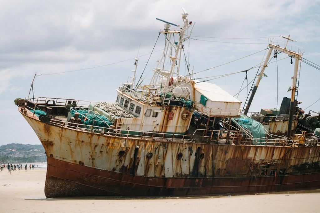 A rusty, abandoned fishing trawler beached on the sand.