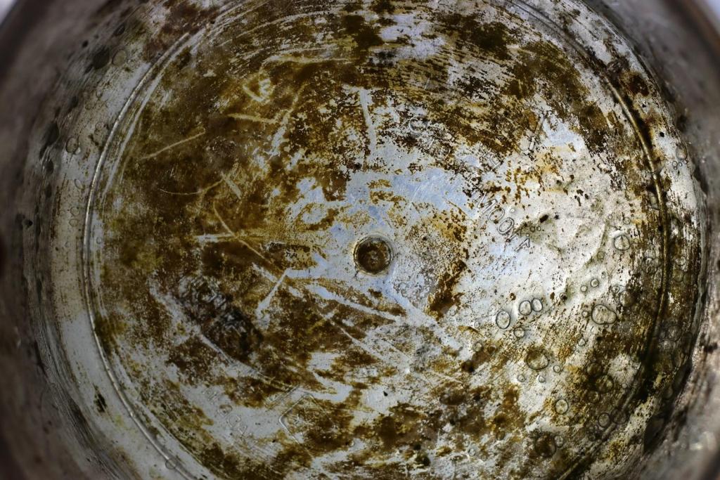 The inside of a dirty bucket is shown.